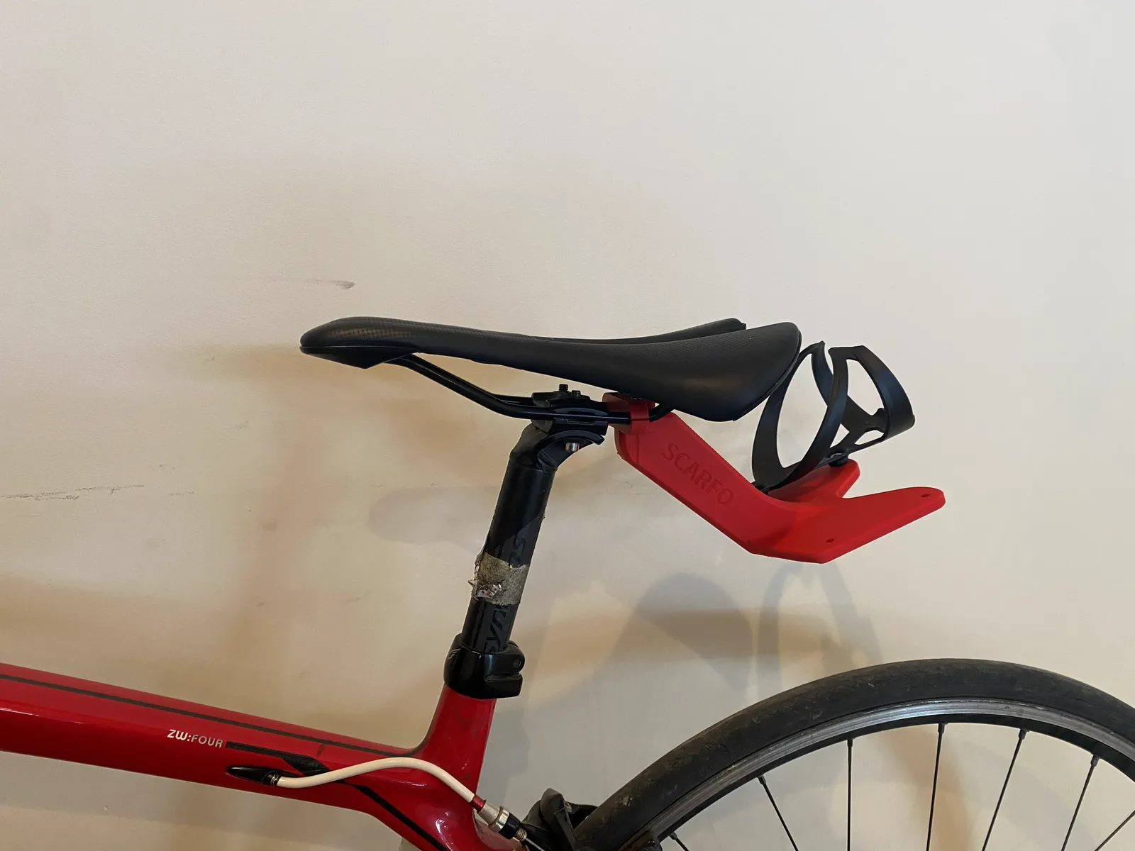 Figure 3. The printed mount installed on the bike, with one cage fitted.