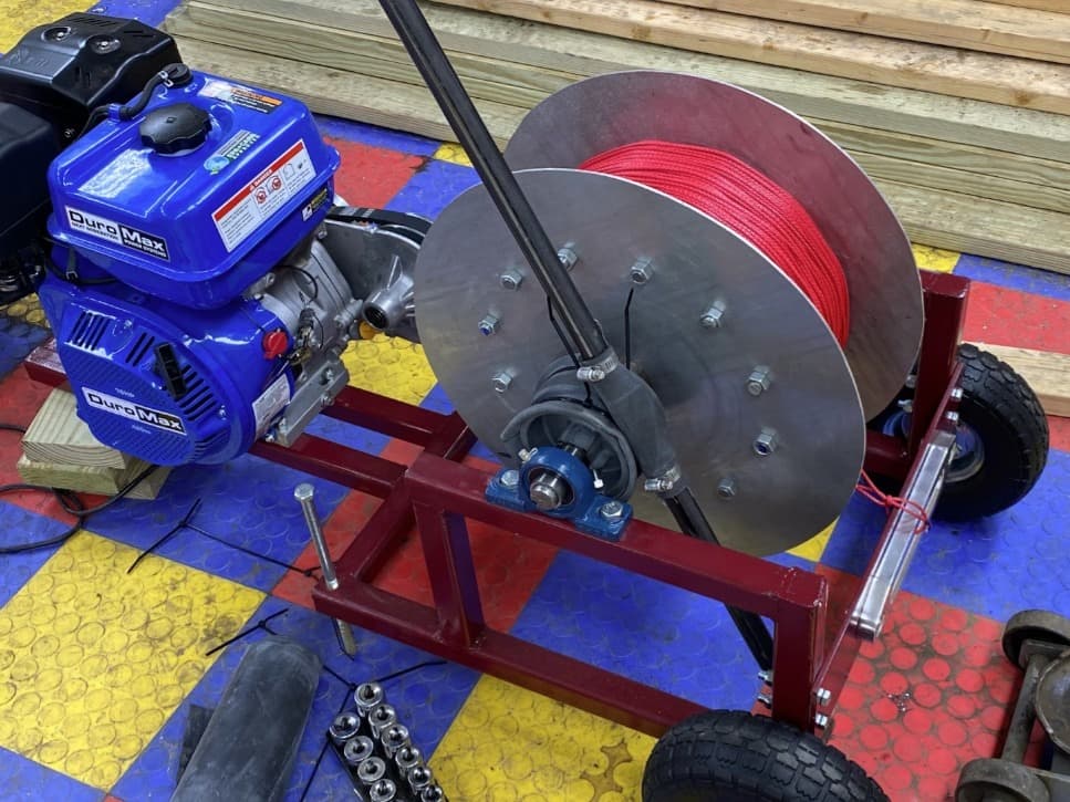 The completed winch — DuroMax engine, the spool wound with Dyneema rope, and the welded steel frame.